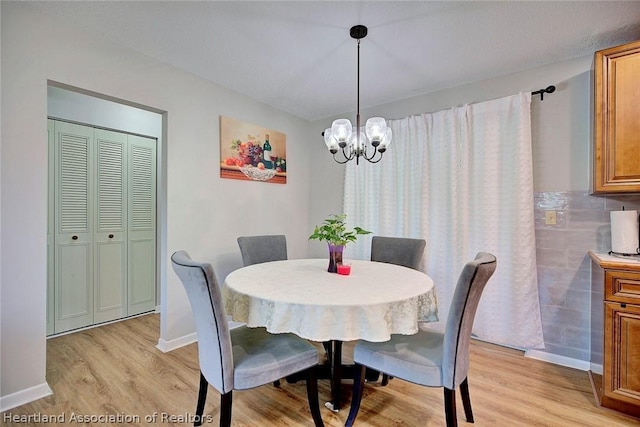 dining area featuring a chandelier and light wood-type flooring