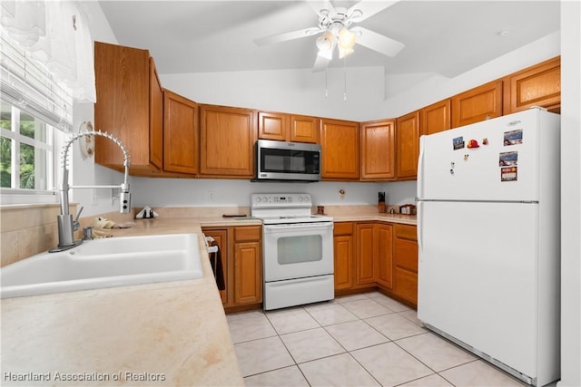 2433 N Highlands Blvd, Avon Park, FL 33825 - kitchen with white appliances, a sink, light countertops, brown cabinets, and vaulted ceiling
