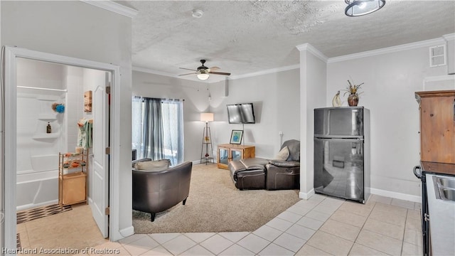 living room featuring a textured ceiling, ceiling fan, crown molding, and light tile patterned flooring