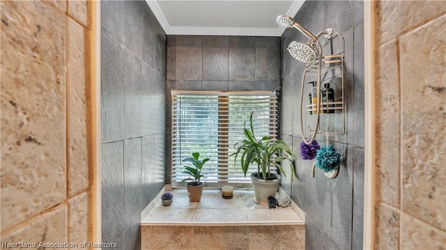 bathroom with crown molding and a shower