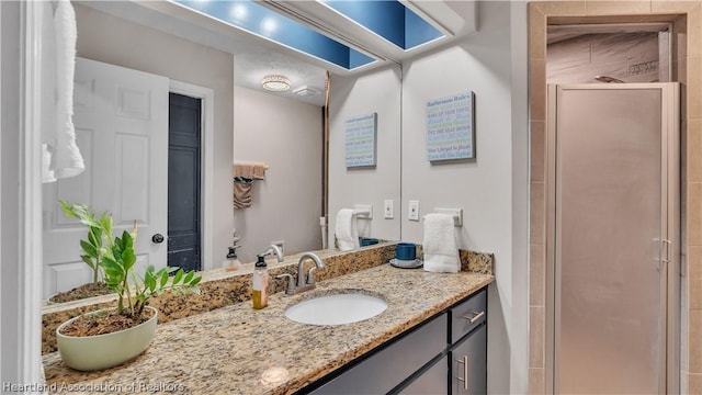 bathroom featuring vanity and an enclosed shower