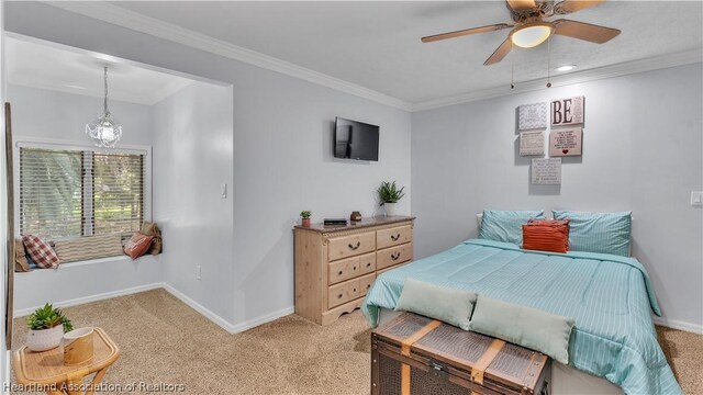 carpeted bedroom featuring ceiling fan and crown molding