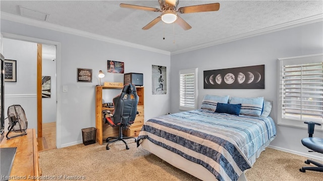 bedroom featuring ceiling fan, crown molding, a textured ceiling, and light carpet