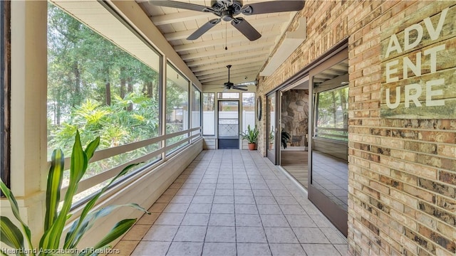 unfurnished sunroom featuring vaulted ceiling, ceiling fan, and wooden ceiling