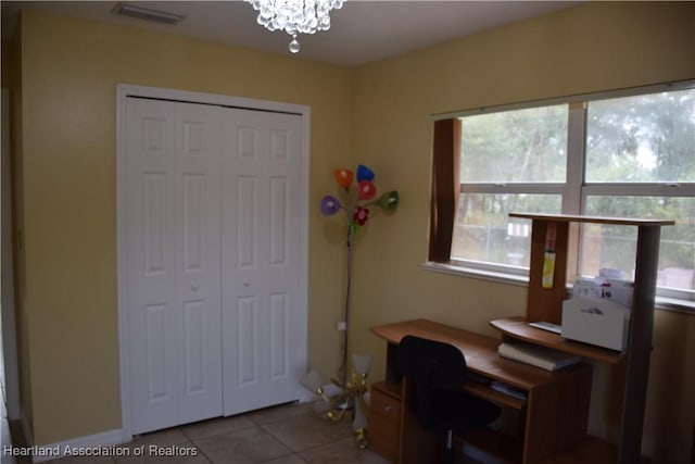 office space with a chandelier, tile patterned flooring, and visible vents