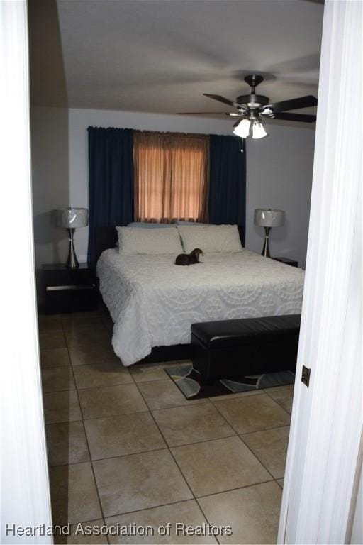 bedroom featuring ceiling fan and tile patterned flooring