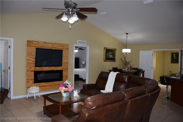 tiled living room featuring a glass covered fireplace, lofted ceiling, baseboards, and ceiling fan with notable chandelier