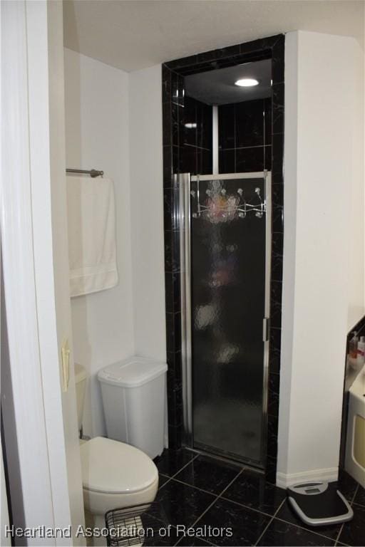bathroom featuring toilet, tile patterned flooring, and a shower stall
