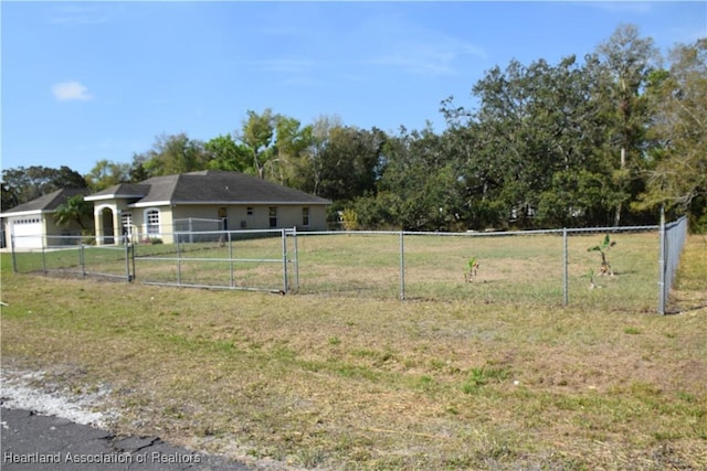 exterior space featuring a garage, a gate, and fence