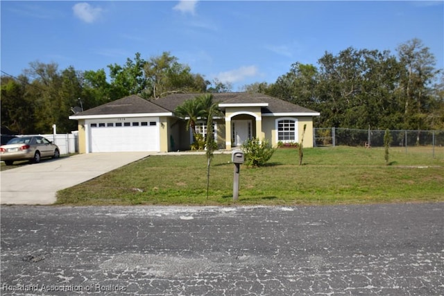 ranch-style house with driveway, fence, and a front yard
