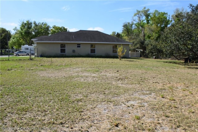 rear view of property with a lawn