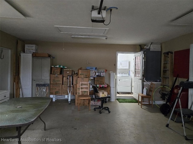garage featuring independent washer and dryer and a garage door opener