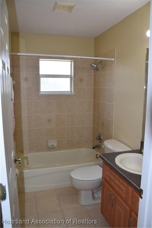 bathroom with visible vents, toilet, vanity,  shower combination, and tile patterned floors