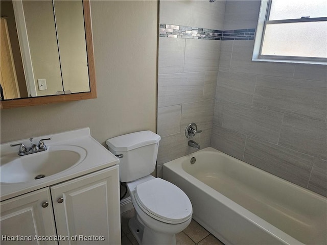 full bathroom with tiled shower / bath, tile patterned flooring, vanity, and toilet