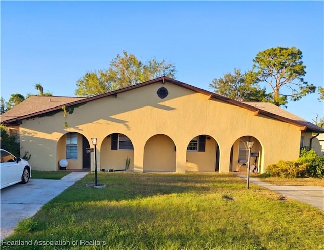 mediterranean / spanish-style house featuring a front yard