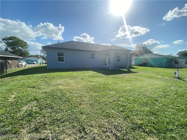 back of house with a lawn