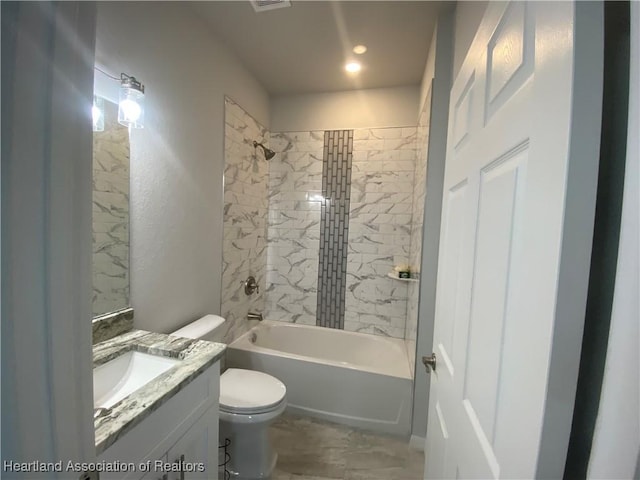 full bathroom with vanity, toilet, and tiled shower / bath