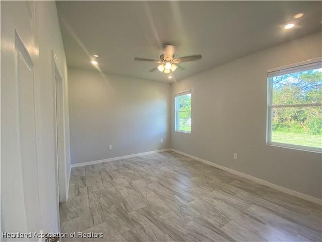 unfurnished room featuring a wealth of natural light and ceiling fan