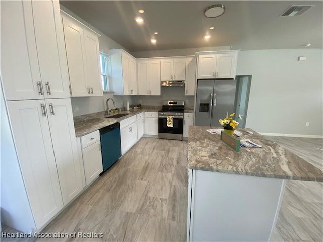 kitchen featuring white cabinetry, light stone counters, and appliances with stainless steel finishes