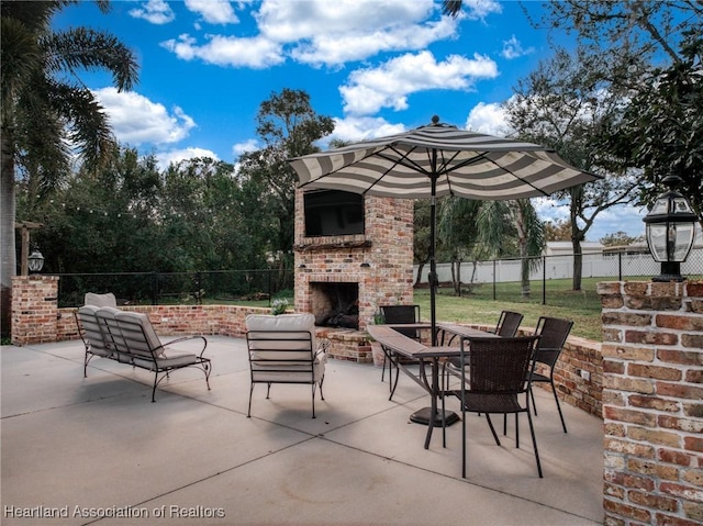 view of patio featuring an outdoor brick fireplace