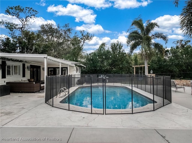 view of swimming pool with an outdoor living space and a patio area