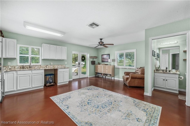 interior space with french doors, white cabinetry, ceiling fan, and a healthy amount of sunlight