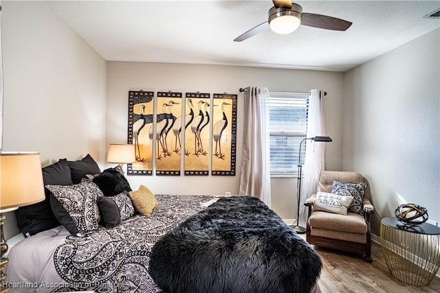 bedroom featuring ceiling fan and wood-type flooring