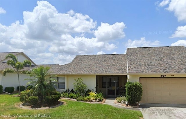 single story home with a front yard and a garage