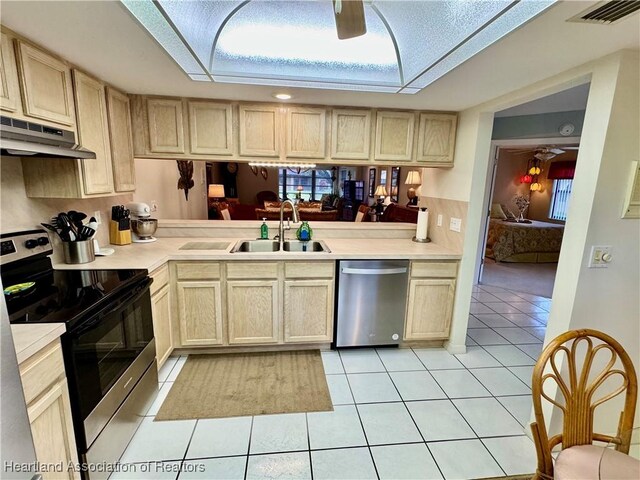 kitchen featuring decorative light fixtures, ceiling fan, light tile patterned floors, and appliances with stainless steel finishes