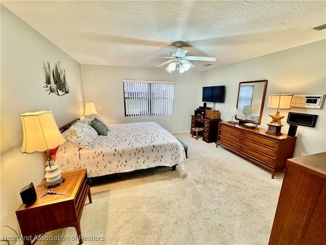 bedroom featuring ceiling fan, a textured ceiling, and carpet floors