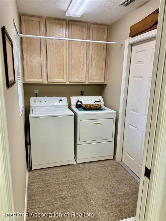 laundry area with cabinets and washing machine and dryer