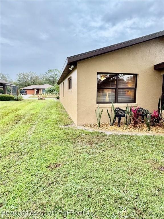 view of property exterior featuring a lawn