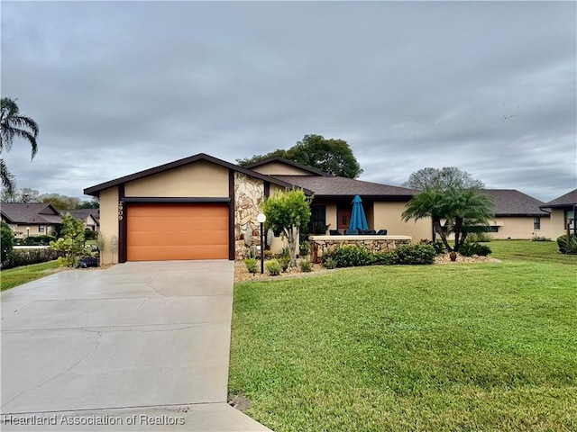 view of front of property with a garage and a front yard