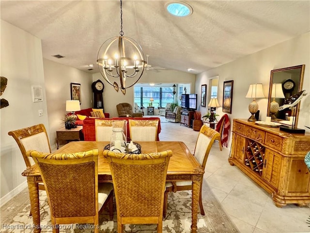 dining room with light tile patterned flooring, a textured ceiling, a chandelier, and vaulted ceiling