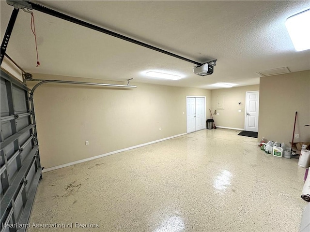 garage with a garage door opener and baseboards