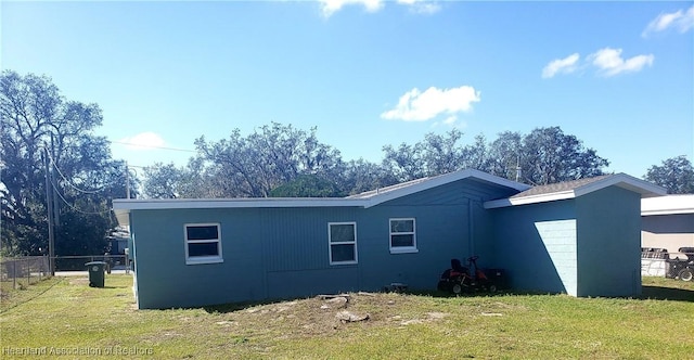 exterior space featuring a lawn and fence