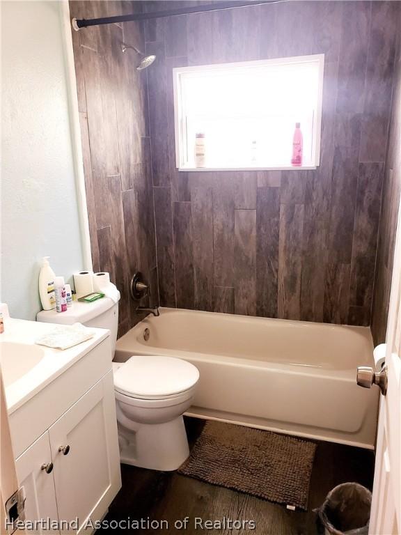 bathroom featuring bathing tub / shower combination, toilet, and vanity