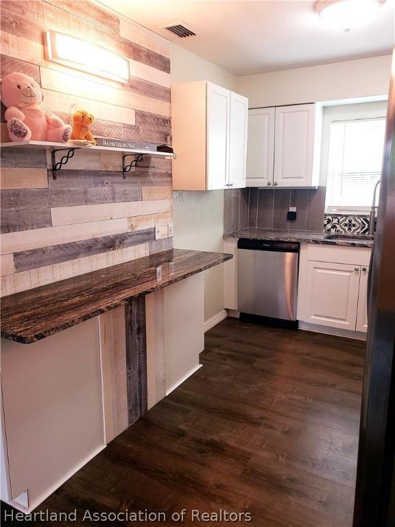 kitchen featuring white cabinets, stainless steel dishwasher, and open shelves