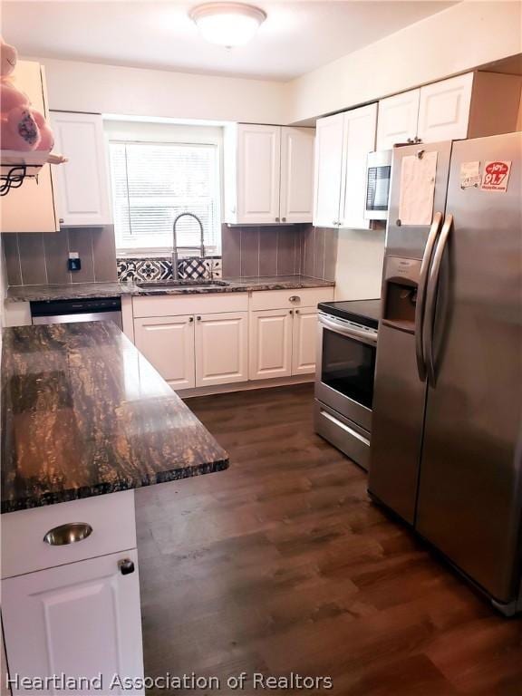 kitchen featuring white cabinetry, appliances with stainless steel finishes, tasteful backsplash, and a sink