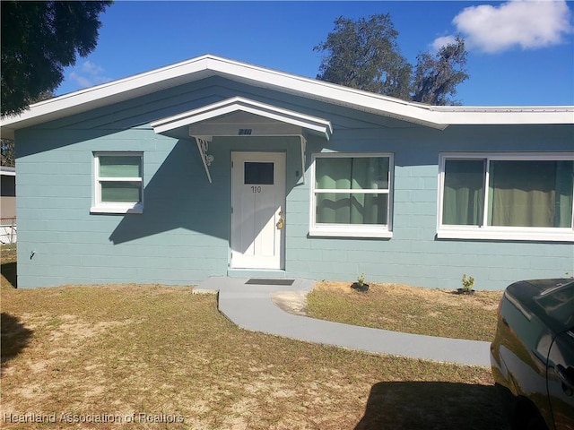 view of front facade with concrete block siding