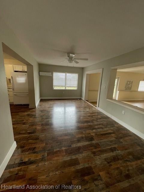 unfurnished room featuring ceiling fan and dark hardwood / wood-style floors