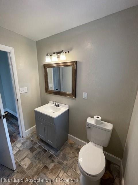 bathroom featuring toilet and vanity