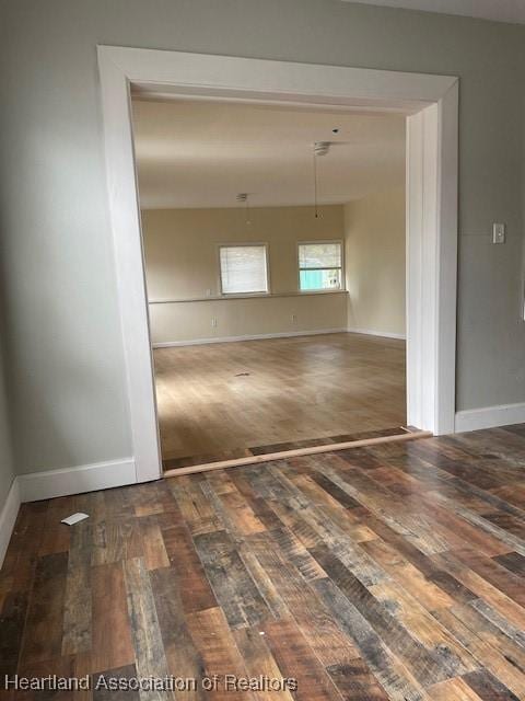 spare room featuring dark hardwood / wood-style floors