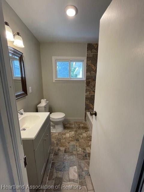 full bathroom featuring toilet, vanity, and tub / shower combination