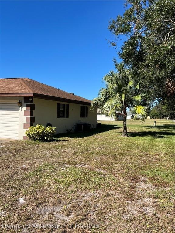 view of side of home with a lawn