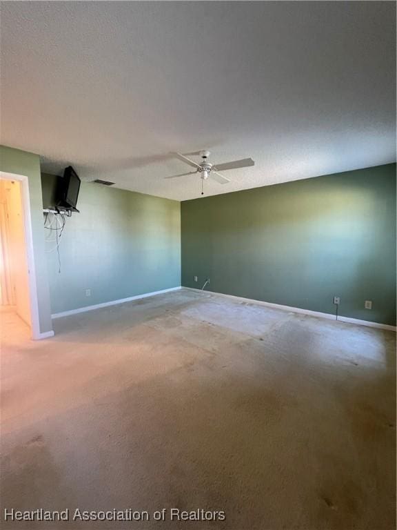 empty room featuring ceiling fan and carpet floors