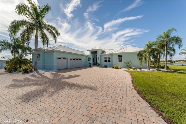 view of front of house with a front yard and a garage