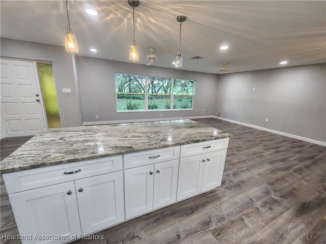 203 Boyer St, Venus, FL 33960 - kitchen featuring light stone countertops, a ceiling fan, open floor plan, and dark wood-type flooring