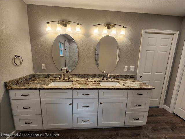 203 Boyer St, Venus, FL 33960 - bathroom with double vanity, a sink, wood finished floors, and baseboards