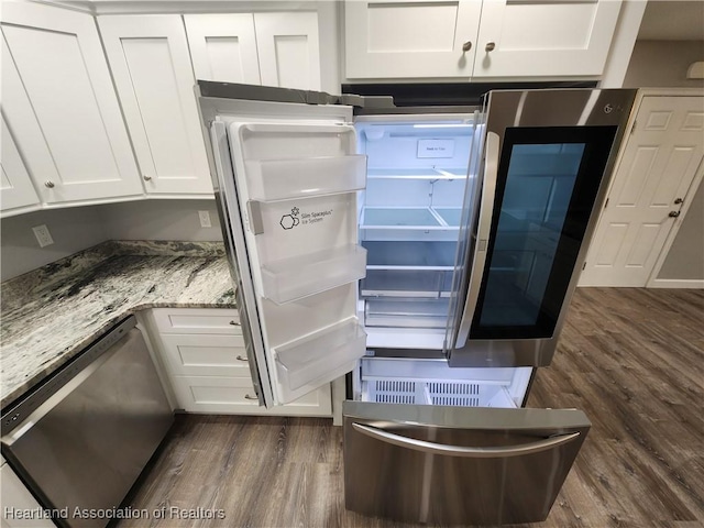 203 Boyer St, Venus, FL 33960 - room details with white cabinetry, stainless steel appliances, dark wood-style flooring, and light stone counters